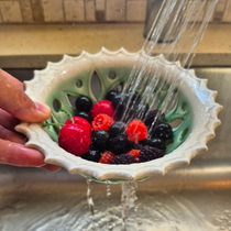 handmade ceramic berry bowl filled with fresh berries and cherries with matching saucer